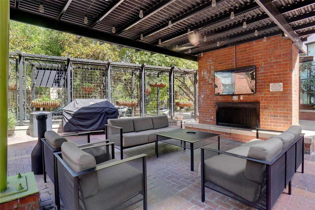 3110 Thomas Avenue, Unit 739 Dallas, TX 75204 - Photo 17 of 18 a outdoor living space with furniture and a fireplace