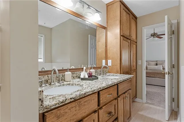 a bathroom with a granite countertop sink and a mirror
