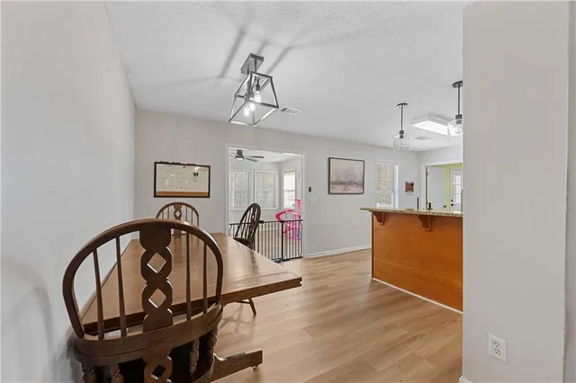 a view of a livingroom with furniture a dinning room and stairs