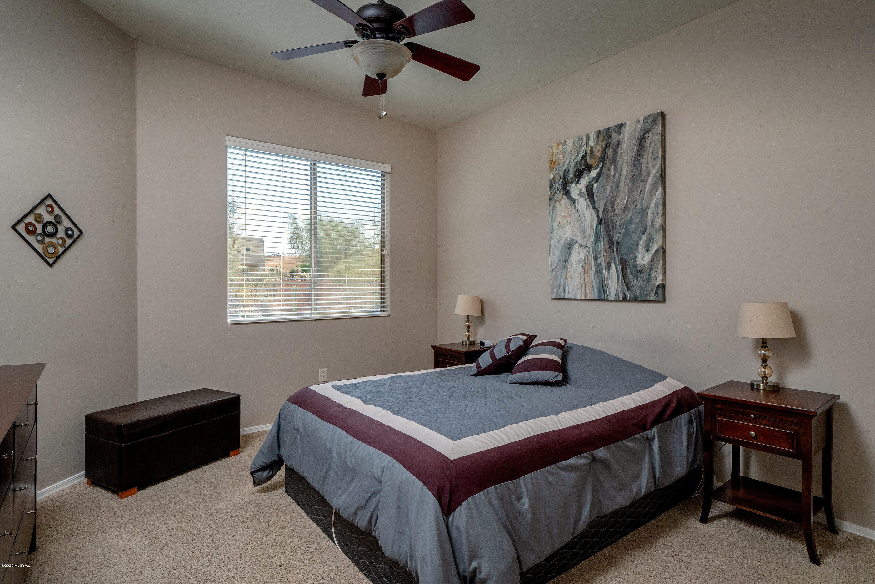 4440 West Crystal Ranch Place Marana, AZ 85658 - Photo 22 of 28 a bedroom with a bed and a chandelier