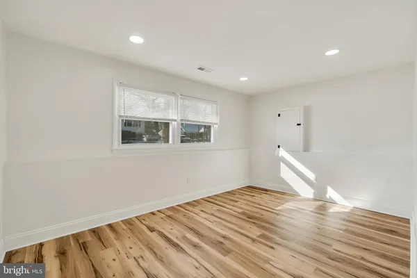 a view of room with window and hardwood floor