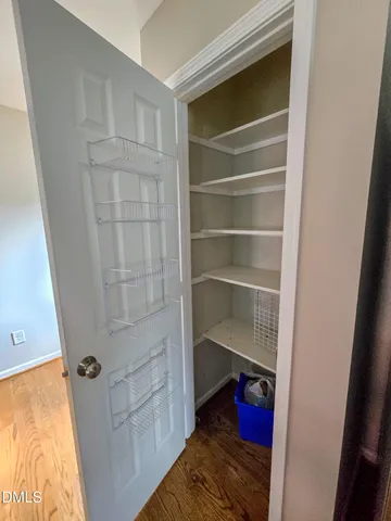 a view of walk in closet with empty racks