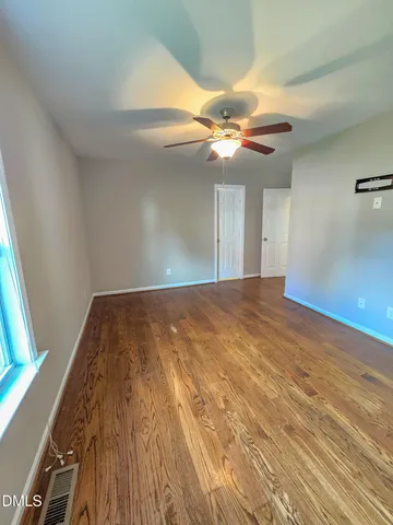 a view of a room with a ceiling fan and a window