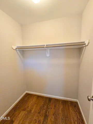 a view of a room with wooden floor