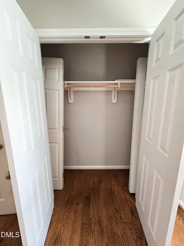 a view of walk in closet with wooden floor