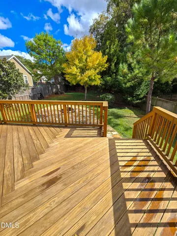 a view of balcony with wooden floor and fence