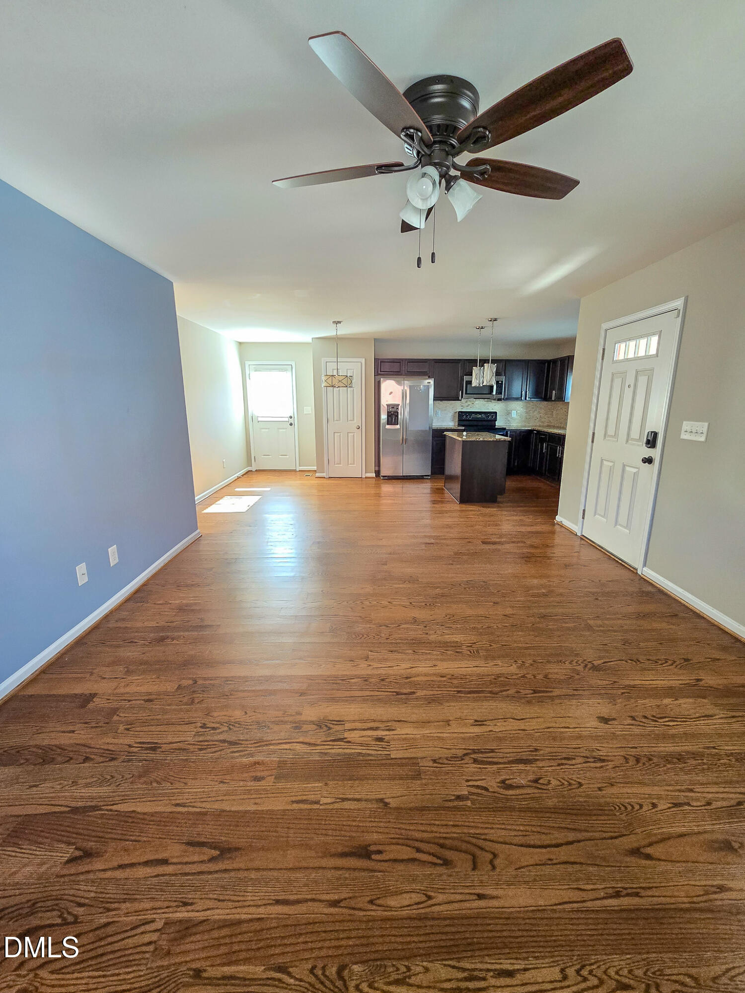 1133 South State Street Raleigh, NC 27601 - Photo 6 of 34 a view of a livingroom with a kitchen island a sink dishwasher and wooden floor