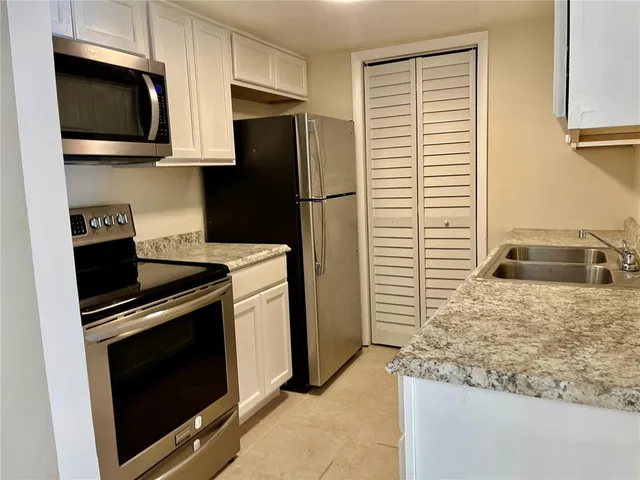 a kitchen with a stove microwave and refrigerator