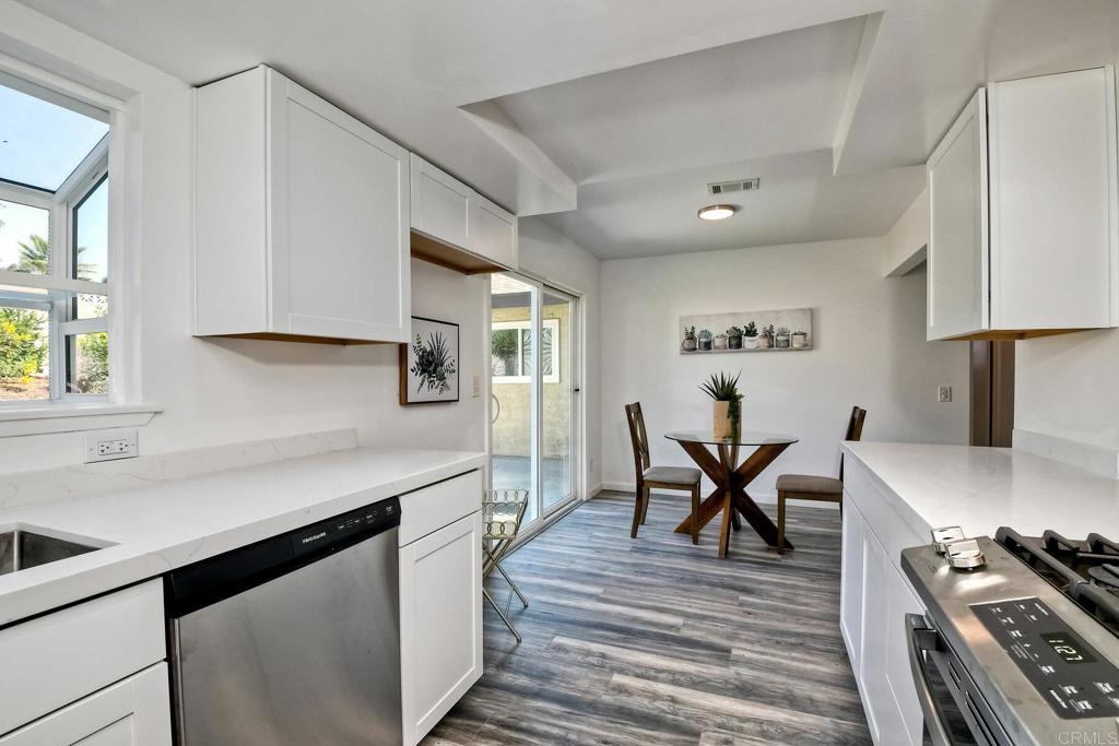 3106 Morningside Drive Oceanside, CA 92056 - Photo 20 of 38 a kitchen with stainless steel appliances granite countertop a stove a sink dishwasher and a refrigerator with wooden floor