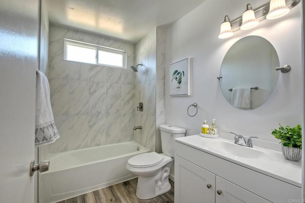 3106 Morningside Drive Oceanside, CA 92056 - Photo 31 of 38 a bathroom with a sink a toilet and a mirror