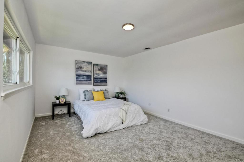 3106 Morningside Drive Oceanside, CA 92056 - Photo 33 of 38 a bedroom with a bed and a table in it