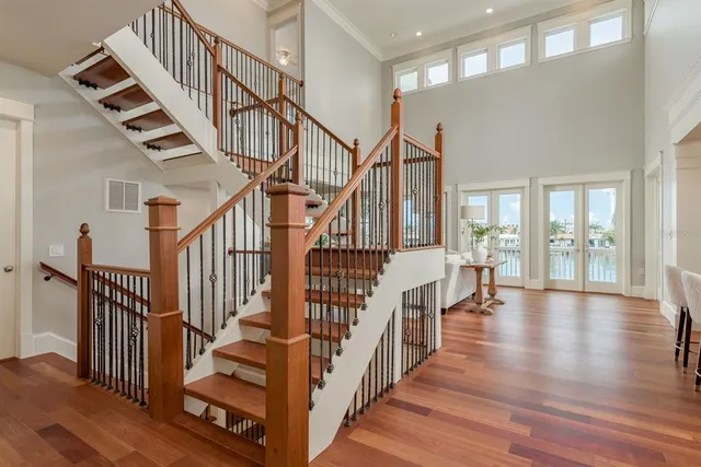 a dining room with furniture a chandelier and wooden floor
