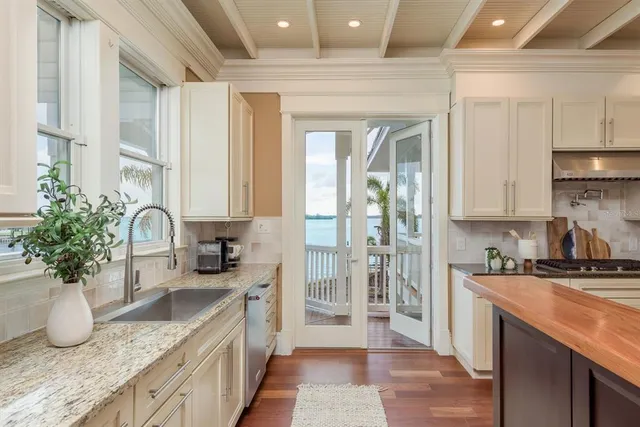 a view of staircase with lots of frames on wall and windows