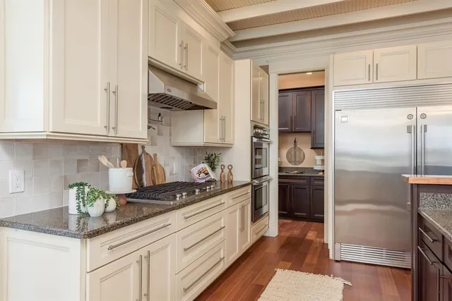 a view of a bedroom with wooden floor and windows