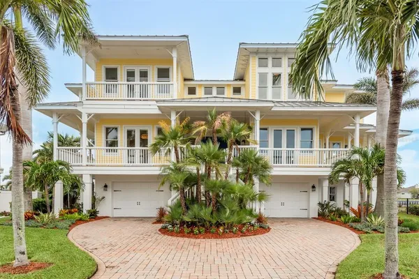 a hallway with wooden floor and a potted plant