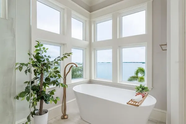 a living room with furniture and a floor to ceiling window