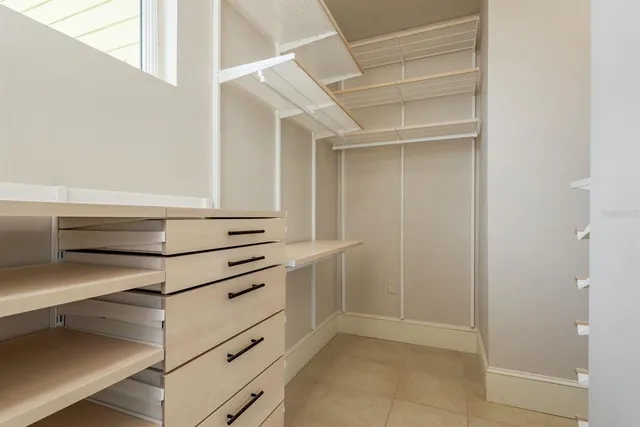 a view of a white house with a yard and potted plants