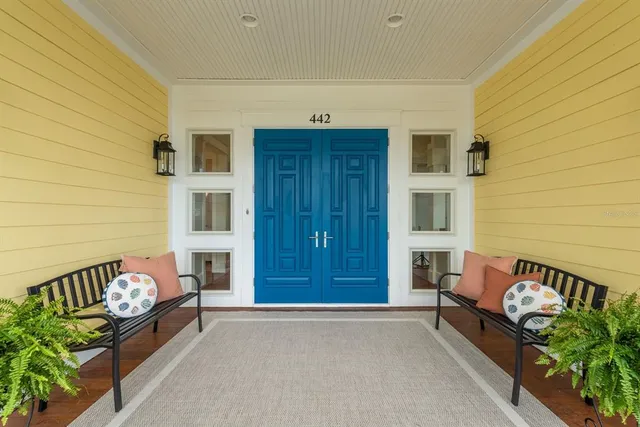 a living room with furniture a wooden floor and next to a window
