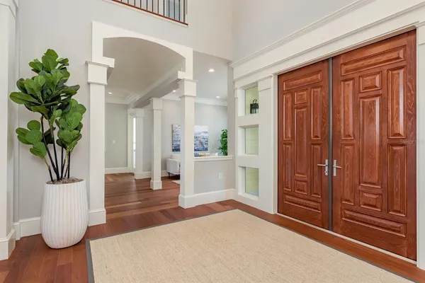 a kitchen with stainless steel appliances granite countertop a table chairs stove microwave and cabinets