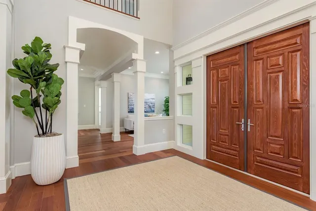 a kitchen with stainless steel appliances granite countertop a table chairs stove microwave and cabinets