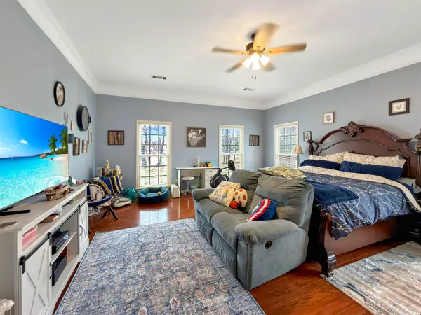 a bedroom with furniture and a flat screen tv