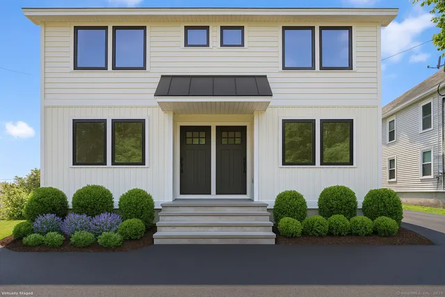 a front view of a house with a yard