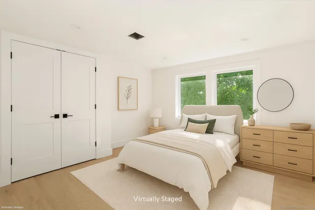 a bedroom with a bed and a mirror