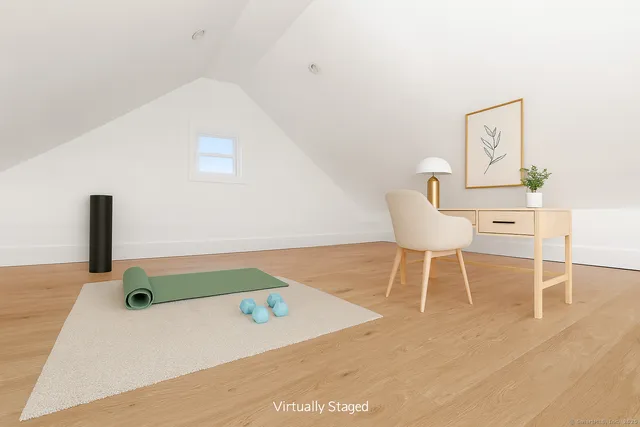 a white chair sitting next to a white wall