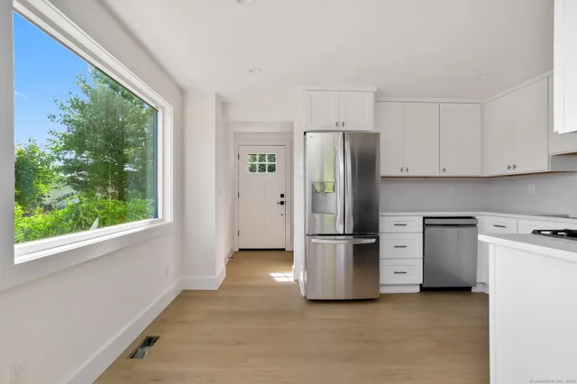 a kitchen with stainless steel appliances a refrigerator sink and stove