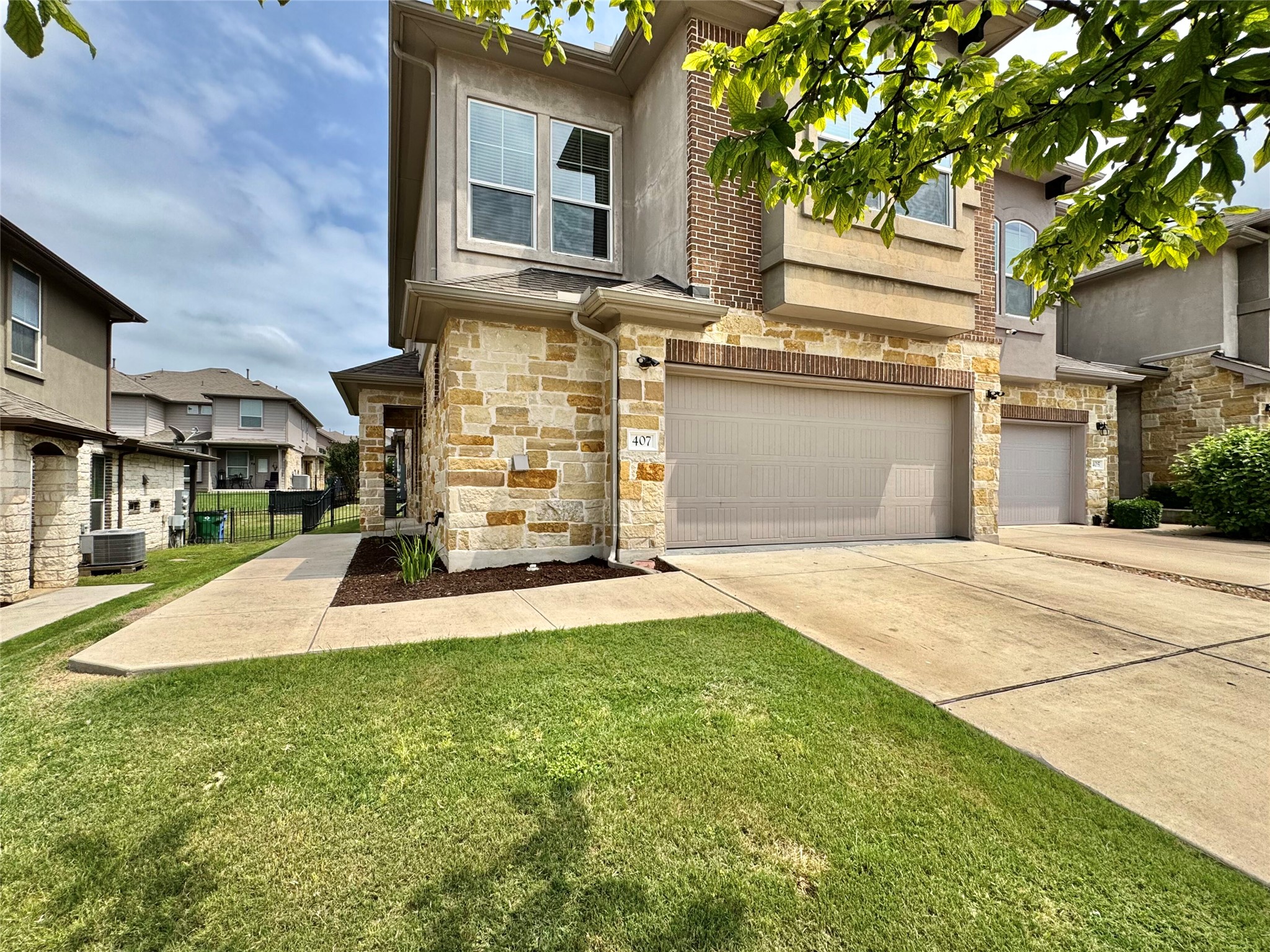 407 Rhetoric Way Pflugerville, TX 78660 - Photo 3 of 38 a front view of a house with a yard