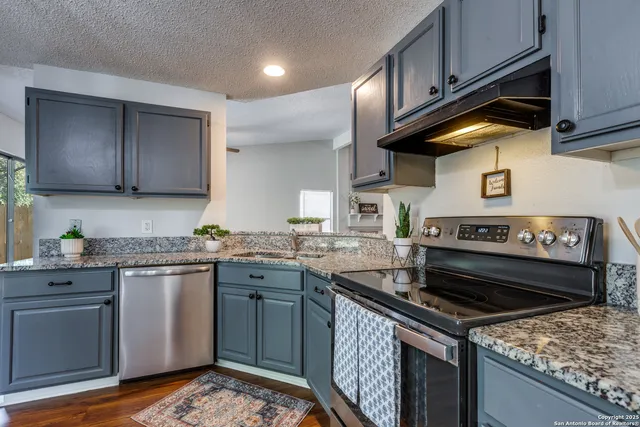 a kitchen with a stove and a sink