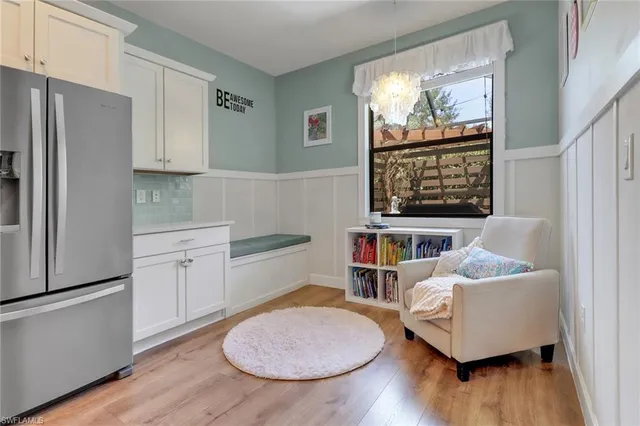 a kitchen with white cabinets a sink and a stove with wooden floor