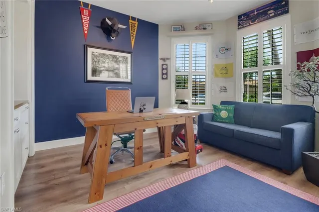 a bedroom with furniture and a large window