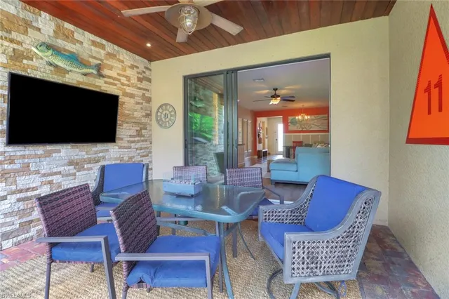 a outdoor living space with furniture and a flat screen tv