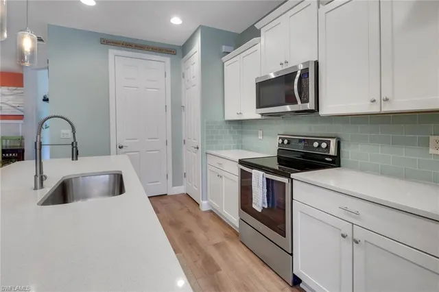 a kitchen with stainless steel appliances a refrigerator stove microwave and cabinets