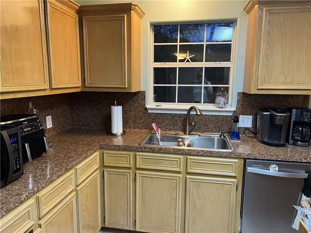 a kitchen with stainless steel appliances granite countertop a sink stove and cabinets