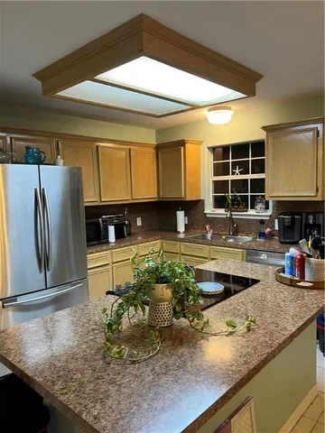 a kitchen with sink and refrigerator