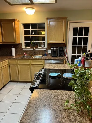 a kitchen with a sink and a stove top oven