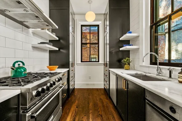 a kitchen with a sink stove and cabinets
