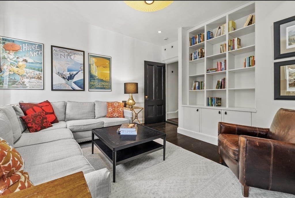 22 Joy Street Boston, MA 02114 - Photo 16 of 36 a living room with furniture a rug and a bookshelf