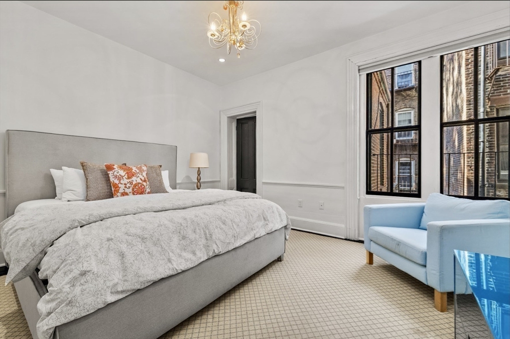 22 Joy Street Boston, MA 02114 - Photo 17 of 36 a bedroom with a large bed and a couch