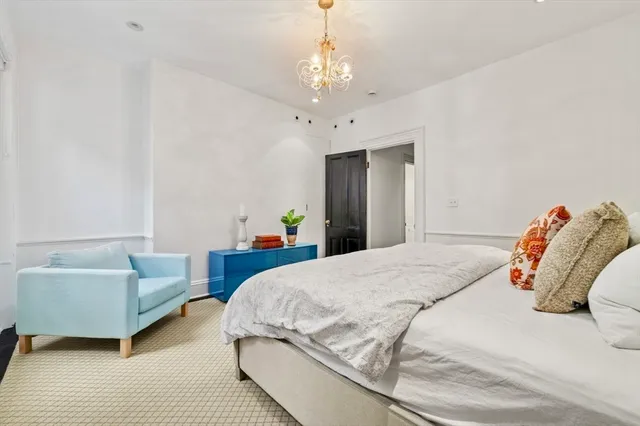 a bedroom with bed and a couch