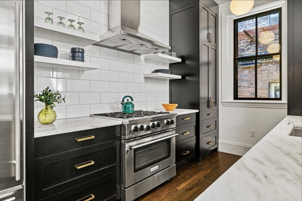 22 Joy Street Boston, MA 02114 - Photo 2 of 36 a kitchen with stainless steel appliances a stove and a window