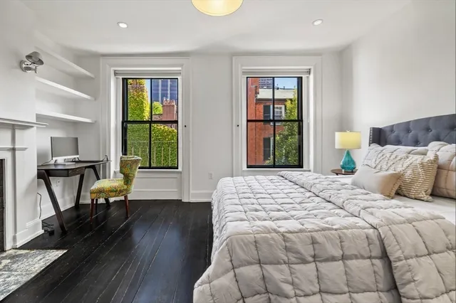 a bedroom with a bed a table and chair