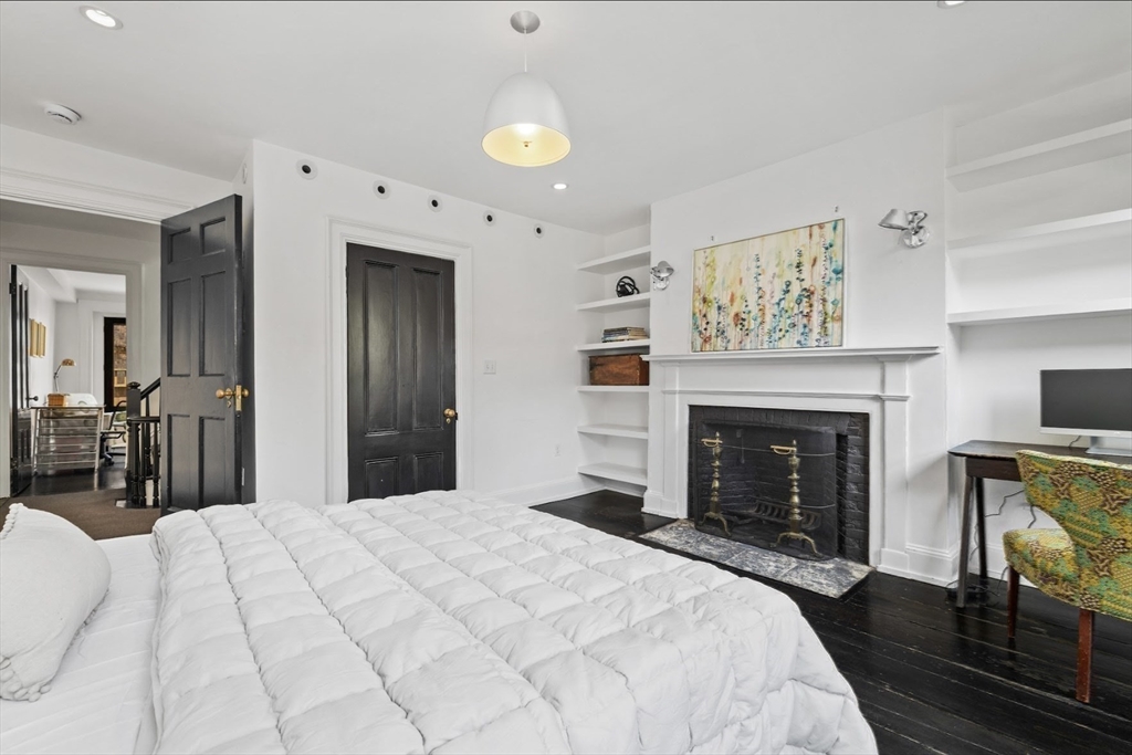 22 Joy Street Boston, MA 02114 - Photo 23 of 36 a bedroom with a bed and a fireplace