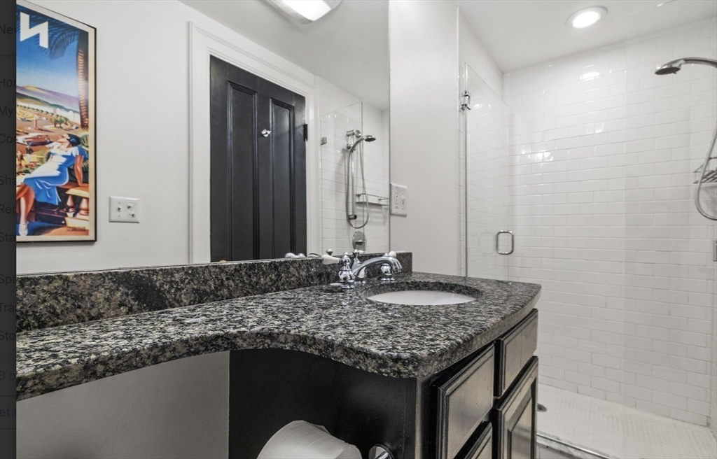 22 Joy Street Boston, MA 02114 - Photo 26 of 36 a bathroom with a granite countertop sink and a mirror