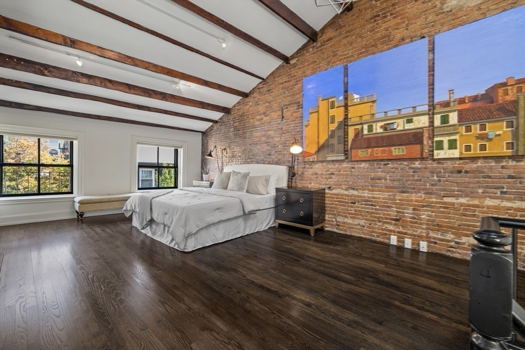 22 Joy Street Boston, MA 02114 - Photo 27 of 36 a spacious bedroom with a bed and a table