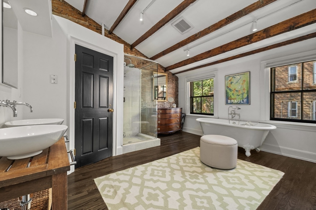 22 Joy Street Boston, MA 02114 - Photo 30 of 36 a living room with furniture a window and a chandelier