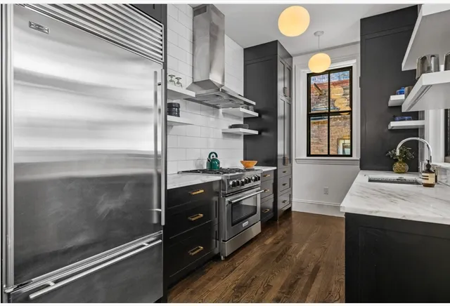 a kitchen with a sink stove and cabinets