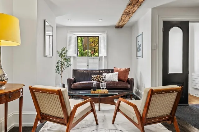 a living room with a couch and a potted plant